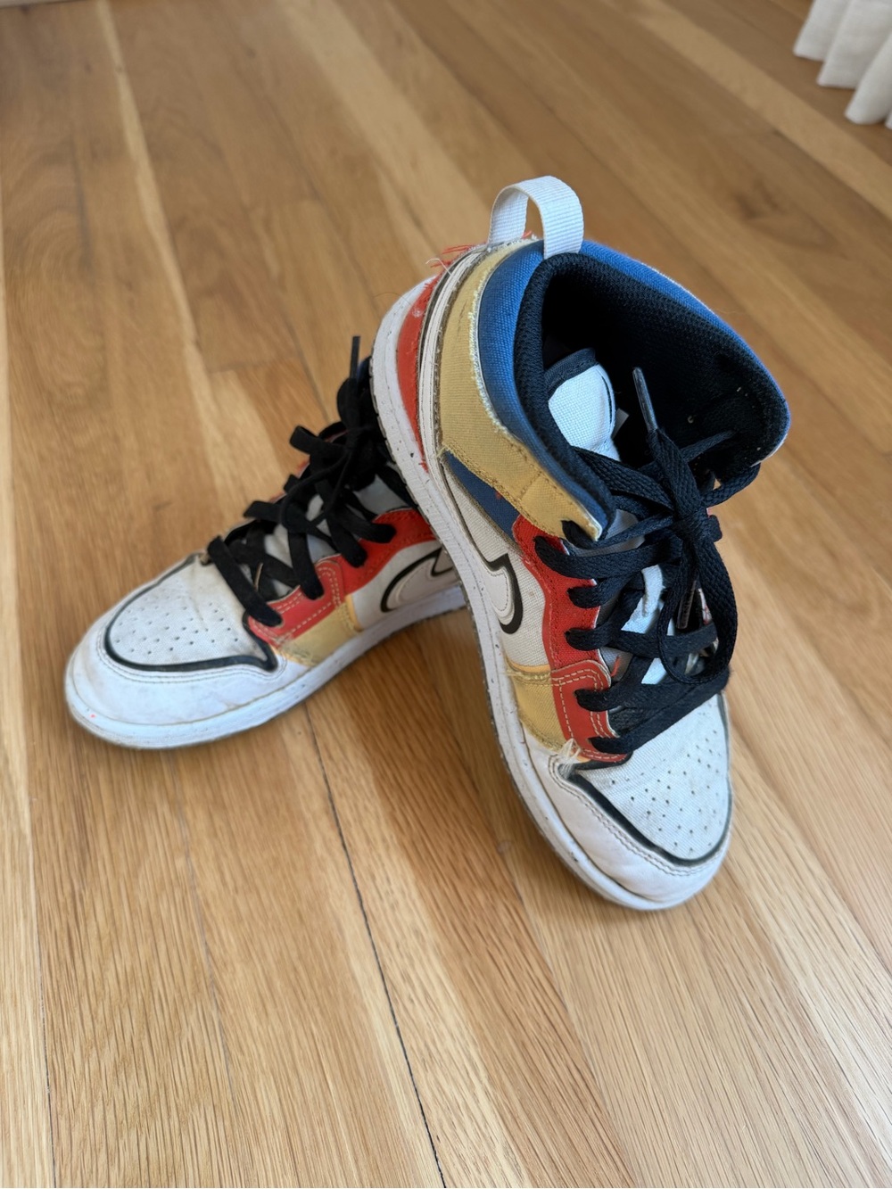 Nike Kids White High-Top Sneakers with Red, Gold & Blue Accents